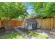 Backyard featuring a charming playhouse structure and mature shade tree at 3177 S Grant St, Englewood, CO 80113