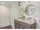 Bathroom boasts dual vanities with stylish mirrors, modern faucets, and white countertop at 3177 S Grant St, Englewood, CO 80113