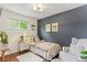 Comfortable bedroom with a neutral palette, window and a cozy reading chair at 3177 S Grant St, Englewood, CO 80113
