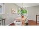 Bright dining area featuring a modern light fixture, large windows, and a charming view at 3177 S Grant St, Englewood, CO 80113
