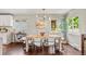 Dining room with modern chandelier, hardwood floors and lots of natural light at 3177 S Grant St, Englewood, CO 80113