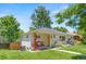 Beautiful front exterior with a well-maintained lawn and a cozy seating area by the front door at 3177 S Grant St, Englewood, CO 80113
