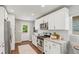 Bright kitchen with white cabinets, modern appliances, and stylish backsplash at 3177 S Grant St, Englewood, CO 80113