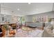 Bright living room with hardwood floors, modern decor, open to kitchen, and lots of light from windows at 3177 S Grant St, Englewood, CO 80113