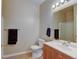 Bright bathroom featuring a single sink vanity, framed mirror, and standard toilet at 3281 E 103Rd Pl # 1403, Thornton, CO 80229