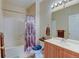Bathroom featuring tub/shower, vanity with sink, framed mirror, and standard toilet at 3281 E 103Rd Pl # 1403, Thornton, CO 80229