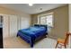 The bedroom has carpet floors, a double closet, a large window, and neutral walls at 3281 E 103Rd Pl # 1403, Thornton, CO 80229