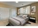 Bedroom with a comfortable bed, closet, and natural light from the window at 3281 E 103Rd Pl # 1403, Thornton, CO 80229