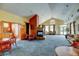 Spacious common area with fireplace, comfortable seating, tables, and ample natural light at 3281 E 103Rd Pl # 1403, Thornton, CO 80229