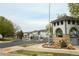 Community entrance with a stone monument, gate, and well-maintained landscaping at 3281 E 103Rd Pl # 1403, Thornton, CO 80229