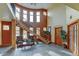 Grand entryway with staircase, tile flooring, large windows, and decorative plants at 3281 E 103Rd Pl # 1403, Thornton, CO 80229