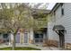 Two-story condo building with stone and siding exterior, balcony, and well-kept landscaping at 3281 E 103Rd Pl # 1403, Thornton, CO 80229
