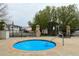 Community hot tub with cover, surrounded by a fence, trees, and nearby picnic table at 3281 E 103Rd Pl # 1403, Thornton, CO 80229