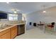Open concept kitchen with breakfast bar that overlooks the living and dining areas at 3281 E 103Rd Pl # 1403, Thornton, CO 80229