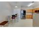 Bright kitchen features stainless steel appliances, wood cabinets, and eat-in dining area at 3281 E 103Rd Pl # 1403, Thornton, CO 80229