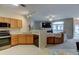 Kitchen features stainless appliances, wood cabinets, recessed lighting, and breakfast bar at 3281 E 103Rd Pl # 1403, Thornton, CO 80229