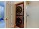 Functional laundry closet features stackable washer and dryer with a shower stall to the side at 3281 E 103Rd Pl # 1403, Thornton, CO 80229