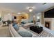 Open floor plan showcases a fireplace, ceiling fan, and access to dining and kitchen at 3281 E 103Rd Pl # 1403, Thornton, CO 80229