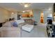 Open living room flows into a kitchen with stainless steel appliances at 3281 E 103Rd Pl # 1403, Thornton, CO 80229