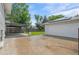 Open backyard featuring a concrete patio and well-maintained lawn, complemented by a detached garage at 5315 Newland St, Arvada, CO 80002