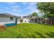 Lush backyard with a well-manicured lawn, patio area, garden bed and detached garage at 5315 Newland St, Arvada, CO 80002