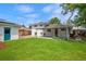 Backyard showcasing a large lawn, patio, and detached garage for ample outdoor space and functionality at 5315 Newland St, Arvada, CO 80002