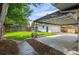 Backyard featuring a well-maintained lawn, patio area, detached garage and wooden fencing at 5315 Newland St, Arvada, CO 80002
