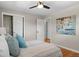 Bright bedroom featuring hardwood floors, a ceiling fan, and ample closet space at 5315 Newland St, Arvada, CO 80002