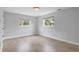 Bright bedroom with tile flooring and two large windows offering natural light and views of the surrounding area at 5315 Newland St, Arvada, CO 80002