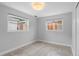 Neutral bedroom with tile flooring and two windows providing natural light and a simple, clean aesthetic at 5315 Newland St, Arvada, CO 80002