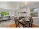 Bright dining room area with wood floors, updated lighting fixture, and seamless flow to the living room at 5315 Newland St, Arvada, CO 80002