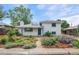 Charming white brick home with landscaped front yard and blue sky, adding to its curb appeal at 5315 Newland St, Arvada, CO 80002