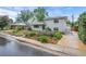 Charming white brick home with landscaped front yard, long driveway and blue sky, adding to its curb appeal at 5315 Newland St, Arvada, CO 80002