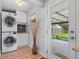 Convenient laundry room featuring stacked washer and dryer and access to the backyard at 5315 Newland St, Arvada, CO 80002