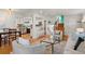 Bright living room featuring hardwood floors with seamless flow to the kitchen and dining area, and stairs at 5315 Newland St, Arvada, CO 80002