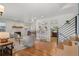 Bright living room featuring hardwood floors, a cozy fireplace, and seamless flow to the kitchen and dining area at 5315 Newland St, Arvada, CO 80002