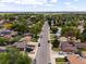 Bird's eye view shows a tranquil residential street lined with mature trees and diverse homes, with cars parked along the sides at 160 Northglenn Dr, Northglenn, CO 80233