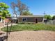 Quaint home with a large backyard featuring green grass and a cozy patio area, great for outdoor entertaining at 160 Northglenn Dr, Northglenn, CO 80233