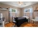 Comfortable bedroom featuring hardwood floors, modern ceiling fan and natural light from two well sized windows at 160 Northglenn Dr, Northglenn, CO 80233