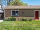Charming home exterior with a well-maintained lawn, decorative details and a bright red front door at 160 Northglenn Dr, Northglenn, CO 80233