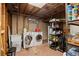 Practical laundry room with modern washer, dryer, and shelving for ample storage solutions at 160 Northglenn Dr, Northglenn, CO 80233