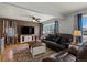 Inviting living room with hardwood floors, a ceiling fan, and stylish decor at 160 Northglenn Dr, Northglenn, CO 80233