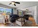 Inviting living room with hardwood floors, ceiling fan, and comfortable leather furniture at 160 Northglenn Dr, Northglenn, CO 80233