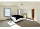 Bright bedroom with large windows, ceiling fan, and neutral-toned walls at 395 Longspur Dr, Brighton, CO 80601