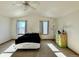 Bright bedroom with large windows, ceiling fan, and carpet floors at 395 Longspur Dr, Brighton, CO 80601