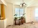 Dining room with a large window and a rustic chandelier at 395 Longspur Dr, Brighton, CO 80601