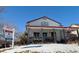 House exterior with front porch and snowy yard at 395 Longspur Dr, Brighton, CO 80601