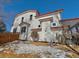 Two-story home with white siding, red accents, and a wooden fence at 395 Longspur Dr, Brighton, CO 80601