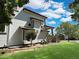 Side view of the property with a well-manicured lawn and attractive landscaping at 395 Longspur Dr, Brighton, CO 80601