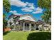 Well-maintained home featuring a spacious wrap-around porch and manicured lawn at 395 Longspur Dr, Brighton, CO 80601